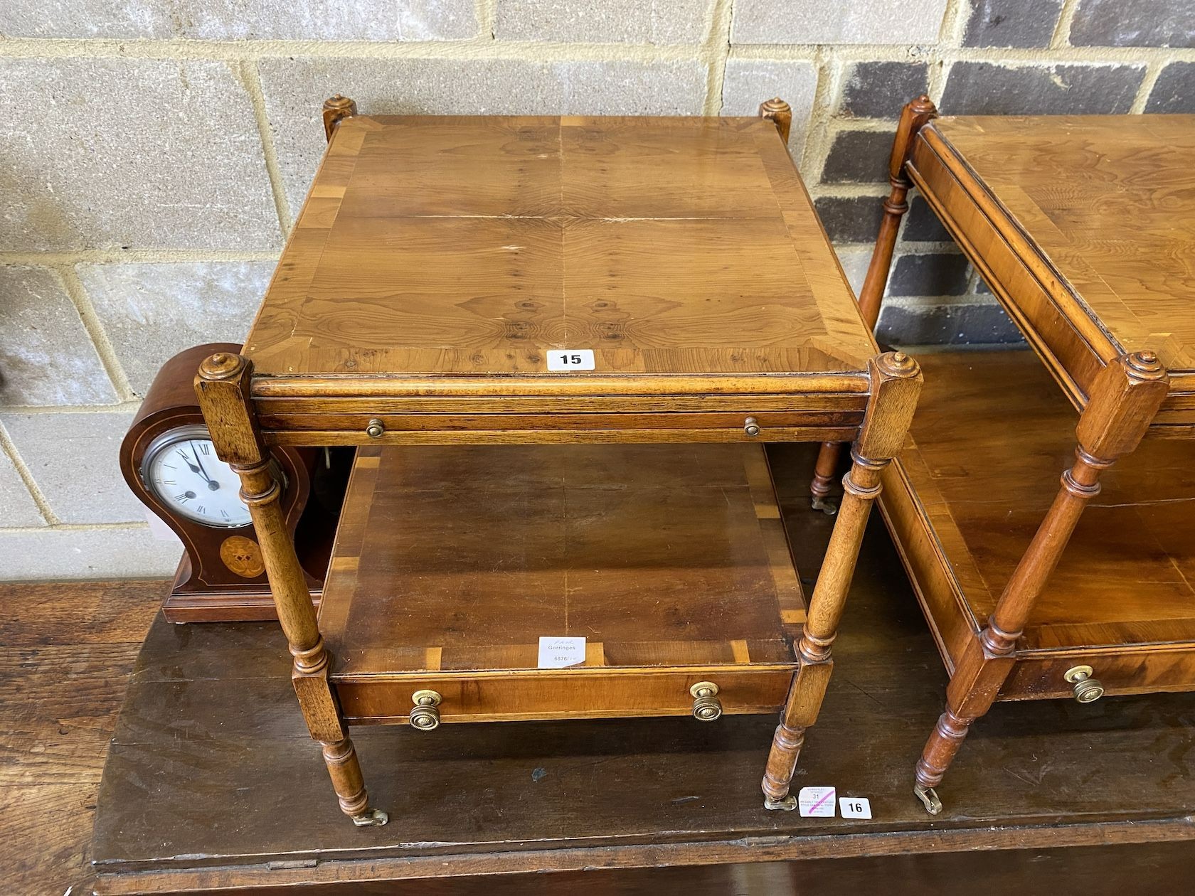 A pair of reproduction yew two tier side tables fitted slides, width 46cm, depth 46cm, height 58cm